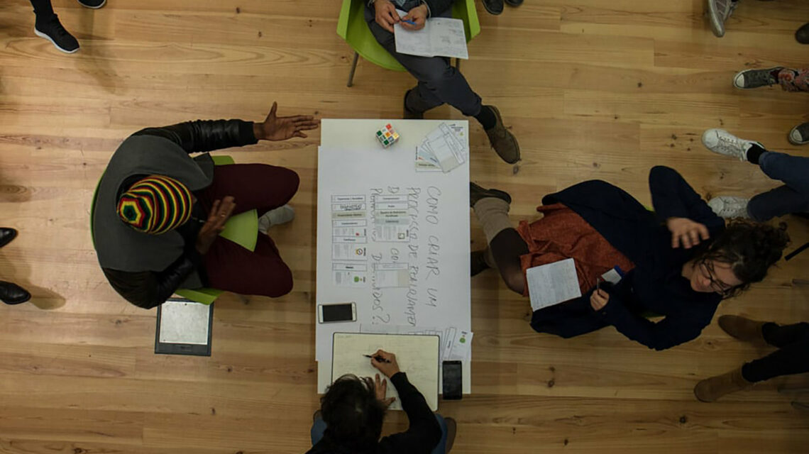 Four people sitting around a table photographed from above